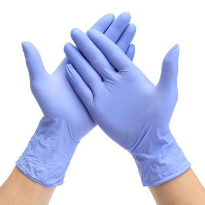 Gants bleus jetables XL de nitriles de soin bleu de main avec la poignée